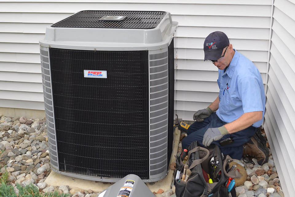 Technician servicing an HVAC unit